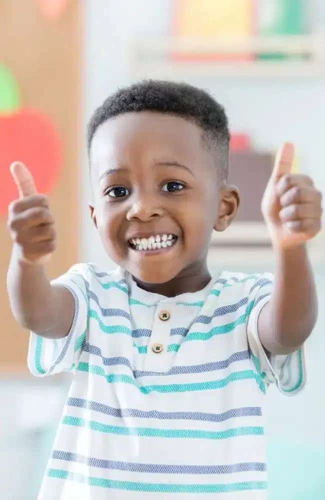 Boy cheering after the pediatric dentist session at Altamonte Springs