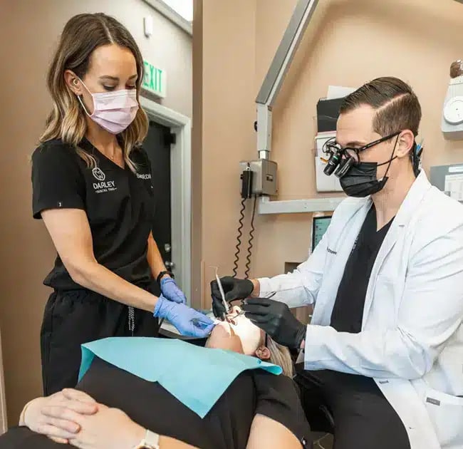 Dentist providing relief for tooth pain under emergency dentistry at Darley Dental Care